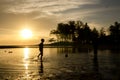 Silhouette image a boy playing beach football over sunrise background Royalty Free Stock Photo