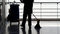 Silhouette of cleaning service people sweeping floor