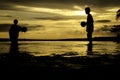 Silhouette image concept of boy playing at the beach during low tide water Royalty Free Stock Photo