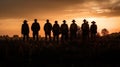 Silhouette image of a group of farmers standing together in a field at sunset