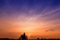 Silhouette image of a man travel by motorcycle at sunset with orange-blue sky background Royalty Free Stock Photo