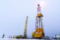 Silhouette image of oil and gas drilling rig in the middle of nowhere with dramatic sky. Onshore land rig in oil and gas industry