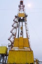 Silhouette image of oil and gas drilling rig in the middle of nowhere with dramatic sky. Onshore land rig in oil and gas industry