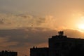 Silhouette image of people flying kites from house terrace in India