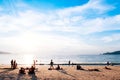 Silhouette image of tourists take sunbathing in evening at Patong beach, Phuket