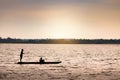 Silhouette image of two boys on a small boat for fishing Royalty Free Stock Photo