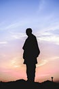 Silhouette image of Worlds tallest statue known as Statue of unity with beautiful sunset sky background in Kevadia, India
