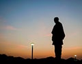 Silhouette image of Worlds tallest statue known as Statue of unity with beautiful sunset sky background in Kevadia, India