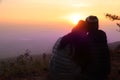 Silhouette images of men and women closer together. Sitting on the hillsides to scenic sky in the morning is beautiful with love