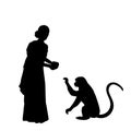 Silhouette Indian woman giving food to the monkey.