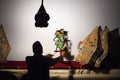 Silhouette of indonesian puppeteer with old javanese shadow puppets