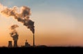 Silhouette of industrial factory smoke stack of coal power plant from chimney up on sky cause air pollution and destroy the Earth Royalty Free Stock Photo