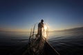 Silhouette of intha fisherman against the sunset sky