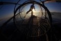 Silhouette of intha fisherman against the sunset sky