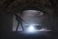 Silhouette of iron worker stoking a furnace in the Blaenavon Iron Works, Wales