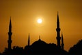Silhouette islamic mosque with dome and two tower with background of sunrising