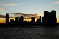 Silhouette of Jersey city with a beautiful Sunset and the Hudson River in the foreground Royalty Free Stock Photo