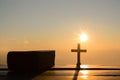 Resurrection of Jesus Christ concept: Silhouette cross with bible on hill sunrise background Royalty Free Stock Photo