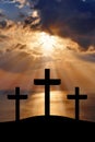 Silhouette of Jesus Christ crucifixion on cross on Good Friday Easter over heaven sunrise -Three Crosses On Hill vertical Royalty Free Stock Photo
