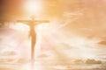 Silhouette Jesus Christ crucifixion on cross over sunset light background, prayer and praise religion concept