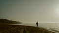 Silhouette jogger woman training on sandy beach. Sportswoman running seacoast. Royalty Free Stock Photo