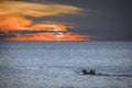 Silhouette of a jukung, a traditional Balinese fishing boat at sunset