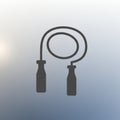 Silhouette of a jump rope with two ergonomic handles, creating a simple and bold icon. The coiled Royalty Free Stock Photo