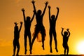 Silhouette of jumping kids against sunset Royalty Free Stock Photo