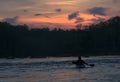 Silhouette of kayaker at sunset