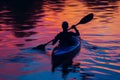 silhouette of a kayaker at sunset, water reflecting colors Royalty Free Stock Photo