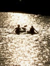 Silhouette of kayakers on the lake at sunset having fun Royalty Free Stock Photo