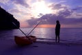 Silhouette kayaking on the beach with tourist girl looking blue sky sunset.