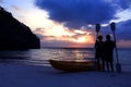 Silhouette kayaking on the beach with tourist girl looking blue sky sunset.