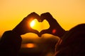 Silhouette of a kid making heart with hands