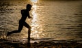 Silhouette of a Kid running over a Surfboard Royalty Free Stock Photo