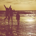 Silhouette of Kids Playing on Beach in Winter Royalty Free Stock Photo