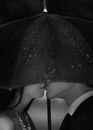 Silhouette of kissing couple under umbrella. Black and white image