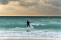 Silhouette of kite surfer at very windy day, dark clouds, big waves, best tropical adventure and extreme sport. Royalty Free Stock Photo