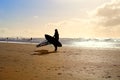 Silhouette of kitesurfer on sand beach