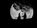 Silhouette Korean lover romance under big tree on full moon background