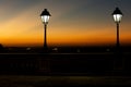 Silhouette of lampposts against sunset Royalty Free Stock Photo