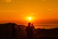 Silhouette landscape at morning time tourist take pictures of the sunrise and mist on the mountain