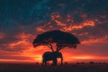 Silhouette of large acacia tree in the savanna plains with elephant. African sunset or sunrise. Wild nature Royalty Free Stock Photo