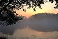 Silhouette leaves frame border with lake and dawn background