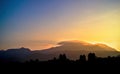 Silhouette of Lenticular Cloud Over Mountain Range at Sunset Royalty Free Stock Photo