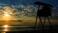 Silhouette of lifeguard tower with beautiful sunshine on the beach