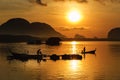 Silhouette Lifestyle Fisherman On Boat Fishing in Morning Golden