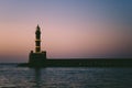 Silhouette of a lighthouse at sunset in Chania Old port