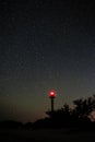 Silhouette of the Lighthouse and trees against the background of the starry sky Royalty Free Stock Photo