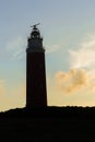 The silhouette of the lighthouse on wadden sea island Texel in the Netherlands with a beautiful evening sky Royalty Free Stock Photo